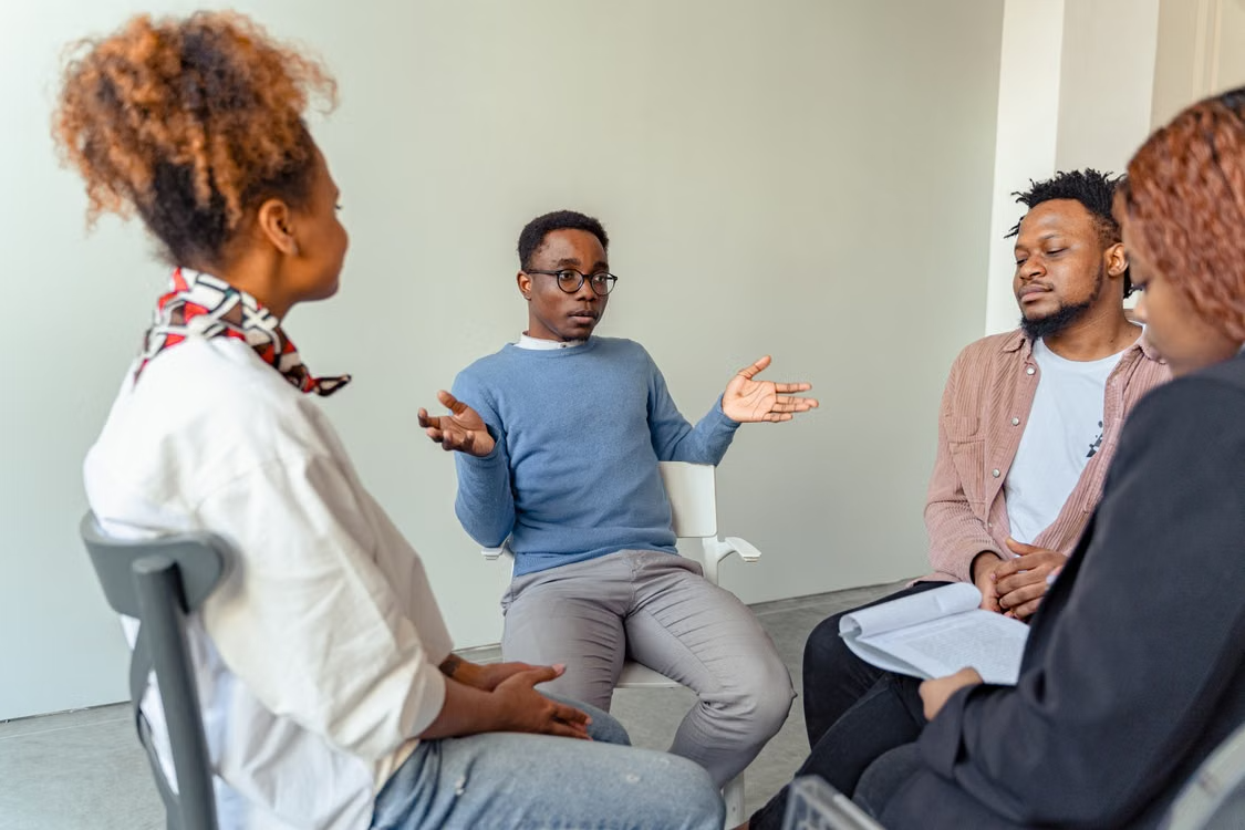 Community members participating in a guided group conversation